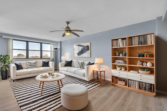 living room with ceiling fan and light hardwood / wood-style floors