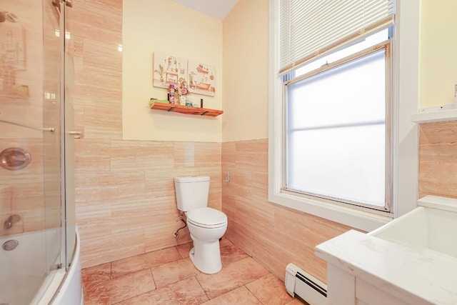 1527 38th St, North Bergen, NJ 07047 - full bathroom with a baseboard heating unit, toilet, healthy amount of natural light, combined bath / shower with glass door, and tile walls