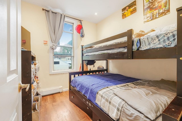 1527 38th St, North Bergen, NJ 07047 - bedroom featuring baseboard heating, wood finished floors, and baseboards