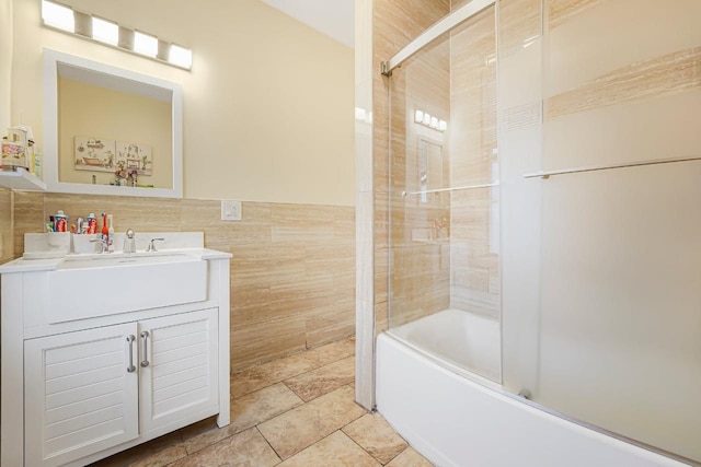 1527 38th St, North Bergen, NJ 07047 - bathroom featuring tile walls, vanity, combined bath / shower with glass door, wainscoting, and tile patterned flooring