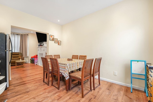 1527 38th St, North Bergen, NJ 07047 - dining space with light wood-type flooring, baseboards, a brick fireplace, and recessed lighting