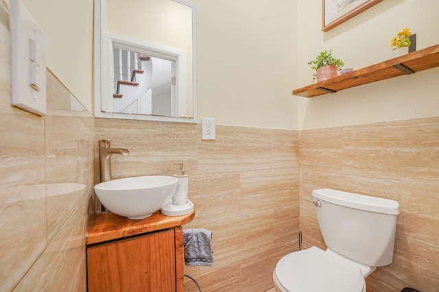 1527 38th St, North Bergen, NJ 07047 - bathroom featuring tile walls, vanity, toilet, and a wainscoted wall