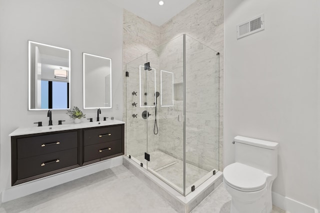 bathroom with toilet, a shower with shower door, and vanity