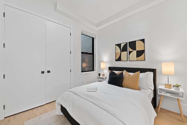 bedroom featuring light wood-type flooring and a closet