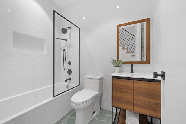 full bathroom featuring tiled shower / bath combo, toilet, tile patterned floors, and vanity