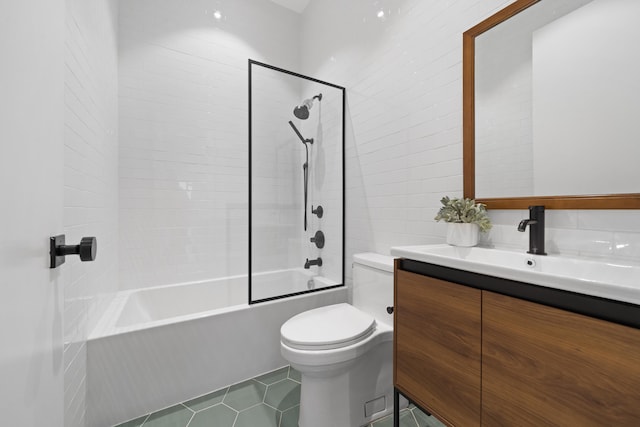 full bathroom featuring toilet, tiled shower / bath, tile patterned floors, and vanity