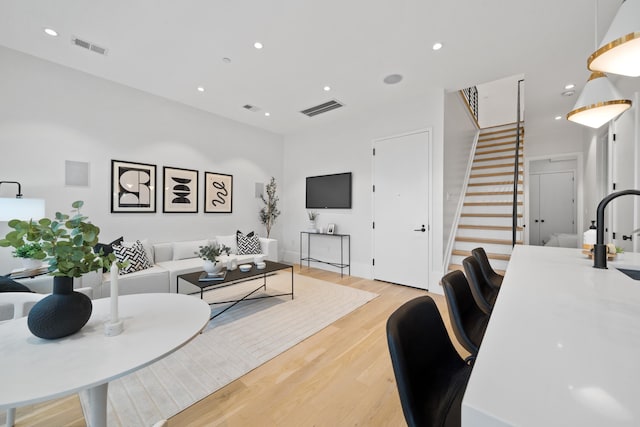 living room featuring sink and light wood-type flooring