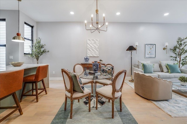 dining area featuring recessed lighting, an inviting chandelier, and light wood-style floors