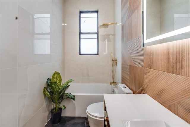 full bathroom featuring vanity, tile walls, and toilet