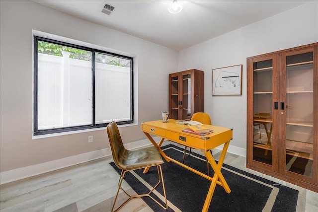 dining space with light wood-type flooring, french doors, visible vents, and baseboards