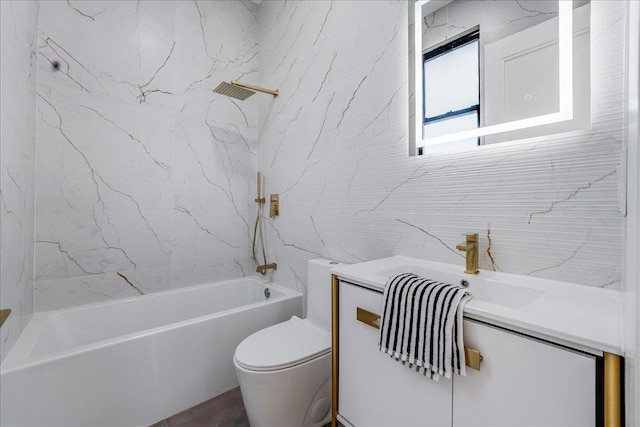 bathroom with vanity, tile walls, toilet, and shower / bathtub combination