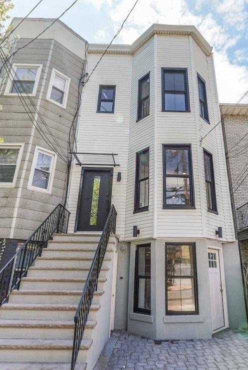 view of front of house with stairs