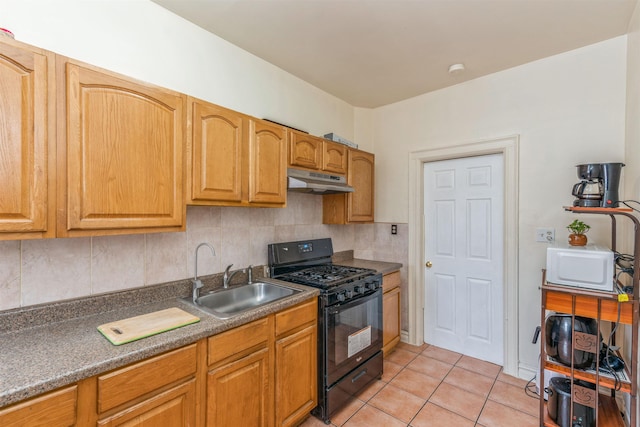 kitchen with light tile patterned flooring, black gas range oven, decorative backsplash, and sink