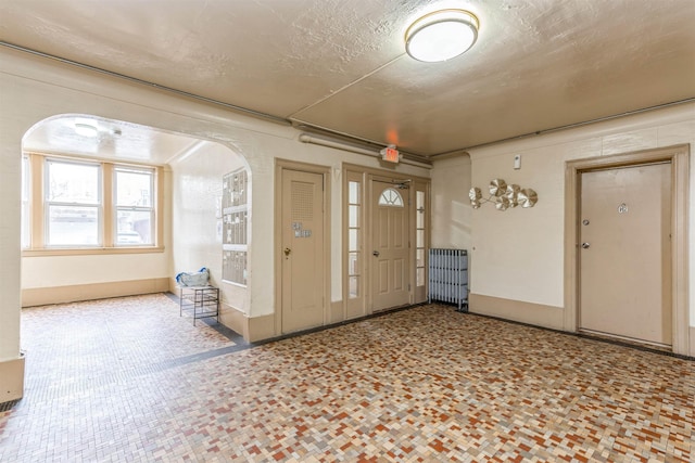 foyer featuring a textured ceiling