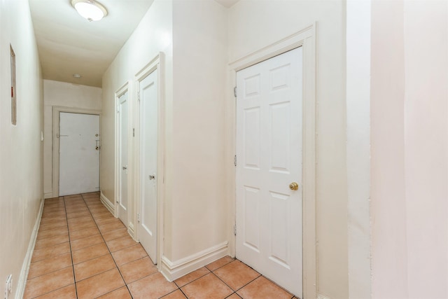 hall with light tile patterned floors