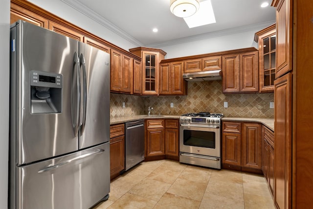 413 Madison St Unit 4, Hoboken, NJ 07030 - kitchen featuring stainless steel appliances, under cabinet range hood, a skylight, crown molding, and brown cabinetry