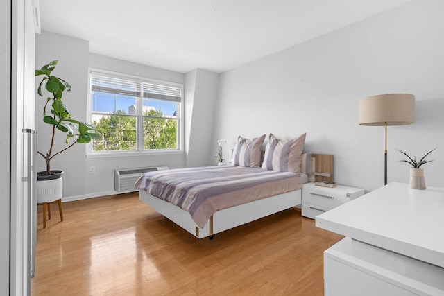4 Constellation Pl Unit 401, Jersey City, NJ 07305 - bedroom featuring a wall mounted AC, light wood finished floors, and baseboards
