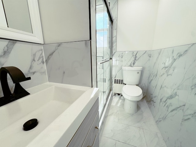 bathroom featuring toilet, tile walls, marble finish floor, a shower stall, and radiator