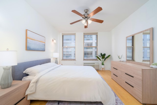 bedroom with ceiling fan and light wood-type flooring