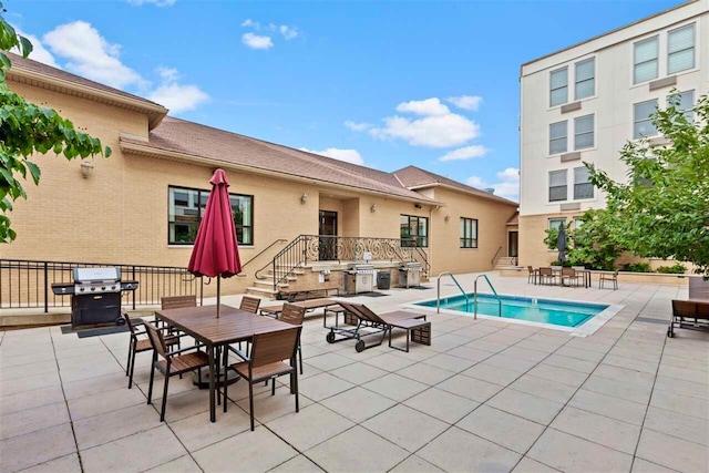 view of pool with a patio and a grill