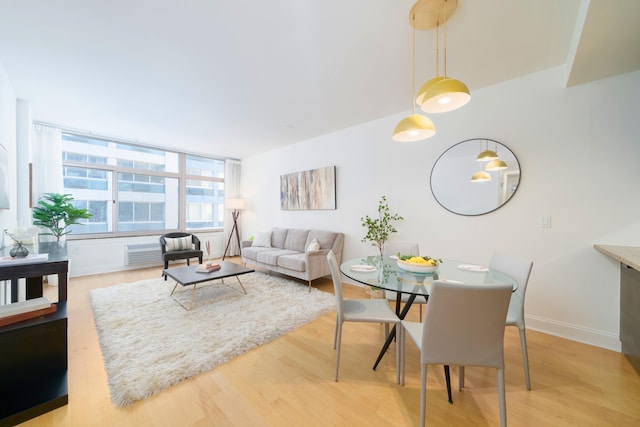 dining space with light hardwood / wood-style floors