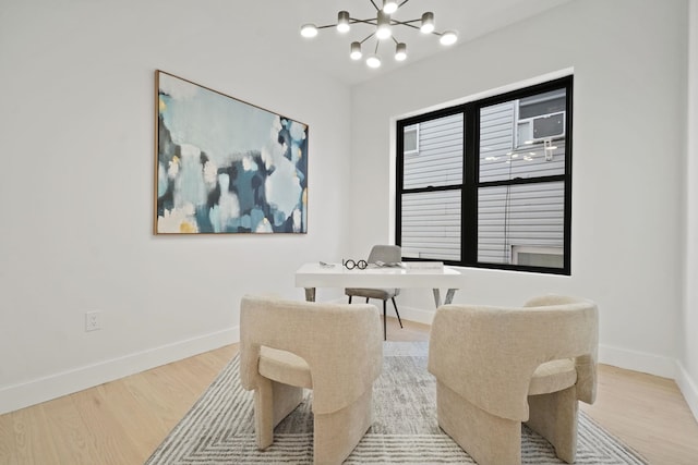 dining area with hardwood / wood-style flooring and a chandelier