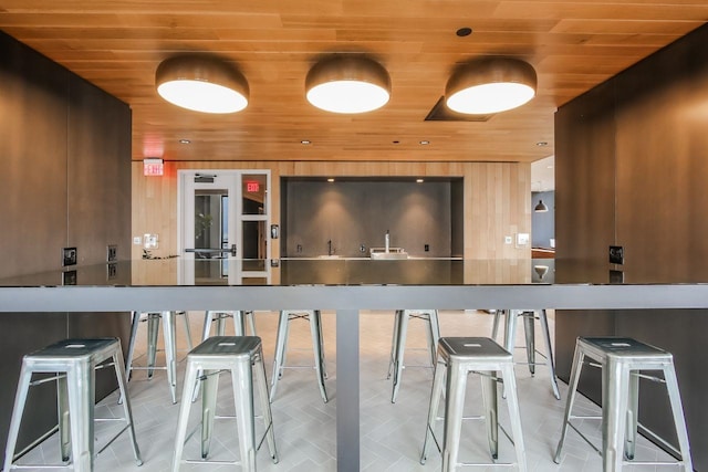 kitchen with wooden ceiling and wood walls