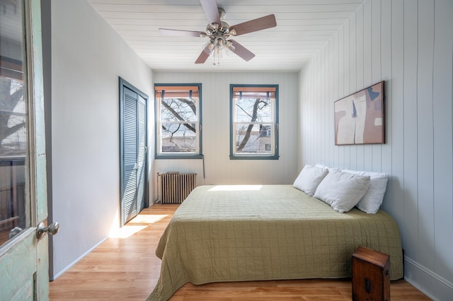 306 Sip Ave Unit 306A, Jersey City, NJ 07306 - bedroom featuring radiator, light wood-type flooring, a closet, and a ceiling fan