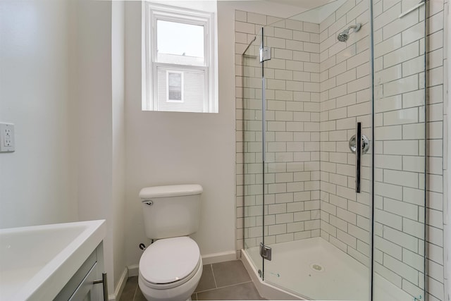 bathroom with toilet, tile patterned floors, a stall shower, and baseboards