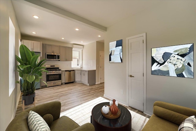 living area featuring light wood-type flooring and recessed lighting