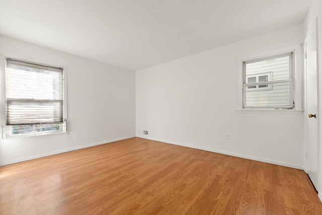 spare room with light hardwood / wood-style flooring