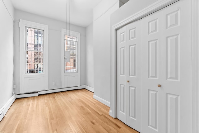 interior space with a baseboard radiator and light wood-type flooring