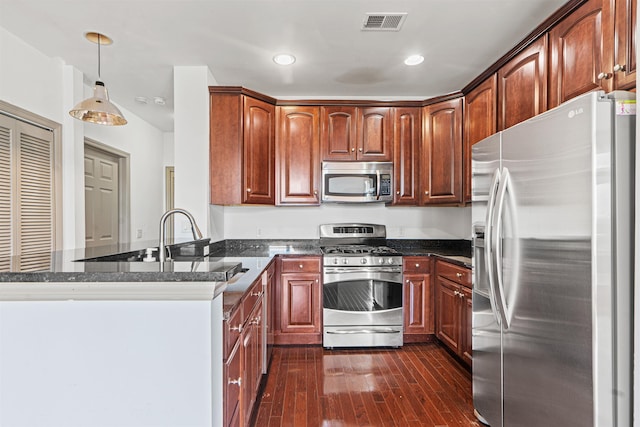 7400 River Rd Unit 304, North Bergen, NJ 07047 - kitchen featuring appliances with stainless steel finishes, a peninsula, dark wood-style flooring, pendant lighting, and dark stone countertops
