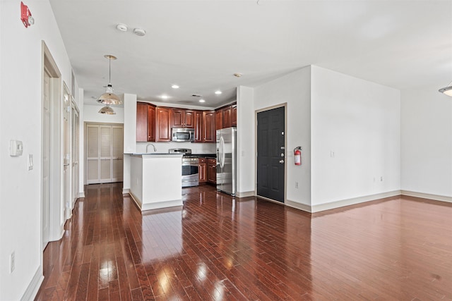 7400 River Rd Unit 304, North Bergen, NJ 07047 - kitchen featuring appliances with stainless steel finishes, dark wood-style floors, open floor plan, baseboards, and a sink