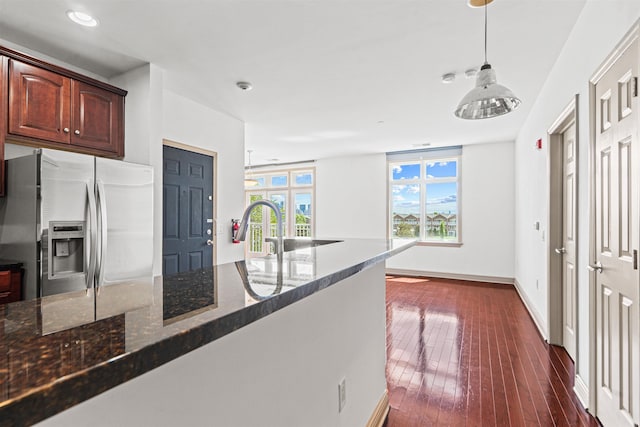 7400 River Rd Unit 304, North Bergen, NJ 07047 - kitchen featuring stainless steel fridge, dark stone countertops, decorative light fixtures, dark wood-type flooring, and recessed lighting