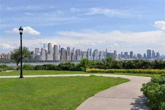 7400 River Rd Unit 304, North Bergen, NJ 07047 - view of home's community with a view of skyline and a lawn