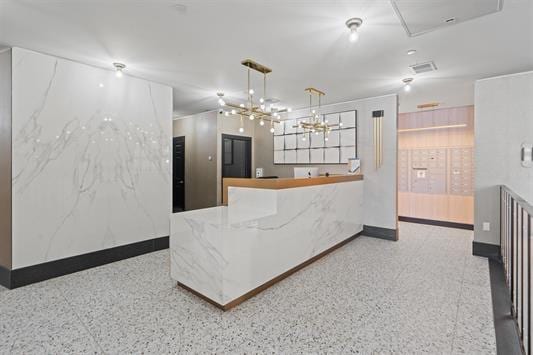 7400 River Rd Unit 304, North Bergen, NJ 07047 - kitchen featuring speckle patterned floor, baseboards, and a chandelier
