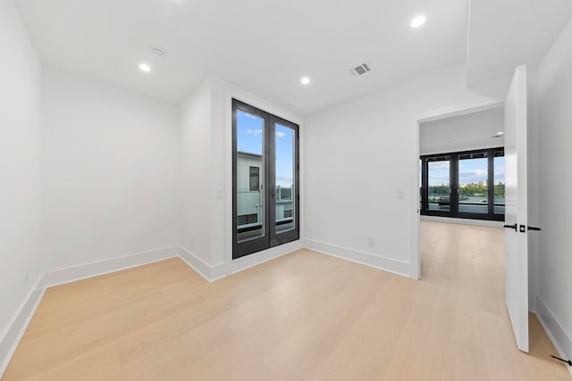 unfurnished room with light wood-type flooring