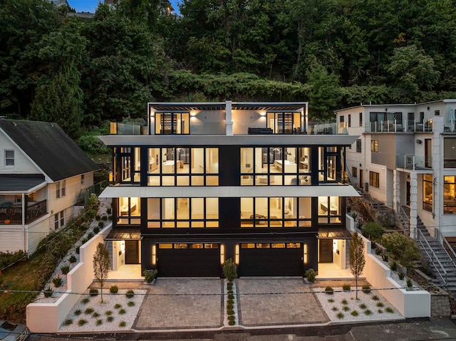 contemporary house featuring a garage and a balcony