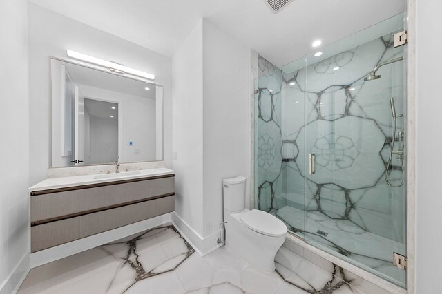 bathroom featuring vanity, toilet, and an enclosed shower