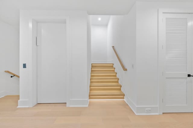 stairs with hardwood / wood-style floors