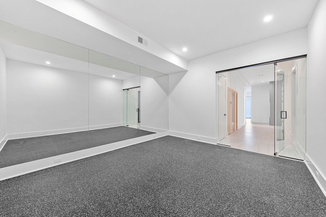 unfurnished room with a barn door