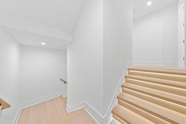 stairs with hardwood / wood-style flooring