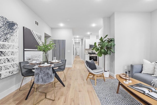 dining area with light hardwood / wood-style floors