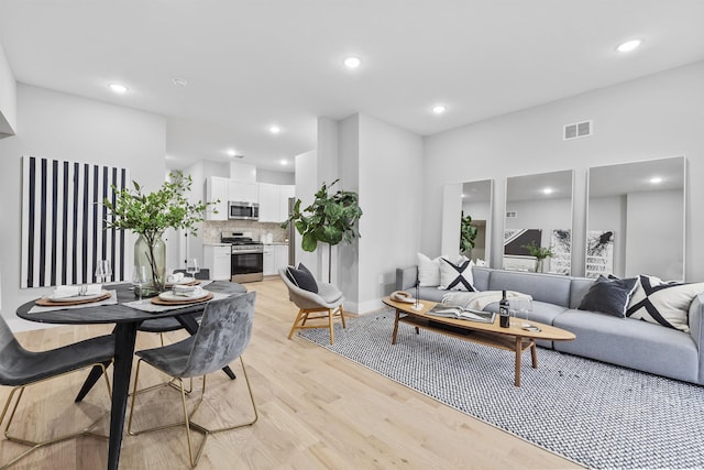 living room with light hardwood / wood-style flooring