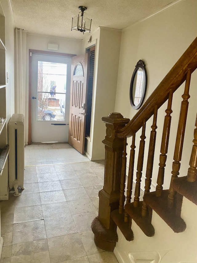 foyer with a textured ceiling