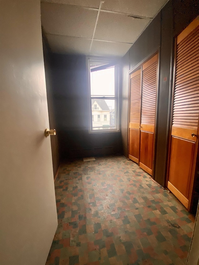 unfurnished bedroom featuring a paneled ceiling