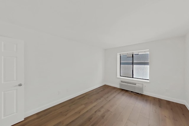90 Ralph St Unit 3, Belleville, NJ 07109 - unfurnished room featuring an AC wall unit, baseboards, and wood finished floors