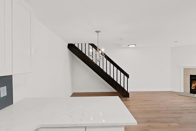 90 Ralph St Unit 3, Belleville, NJ 07109 - stairs with wood finished floors, a warm lit fireplace, and baseboards