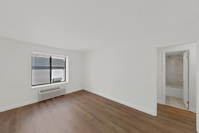 90 Ralph St Unit 3, Belleville, NJ 07109 - unfurnished room with a wall unit AC, wood finished floors, and baseboards